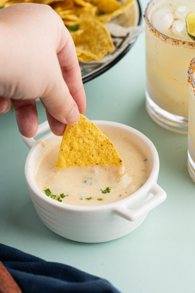 Dipping a tortilla chip into queso Blanco