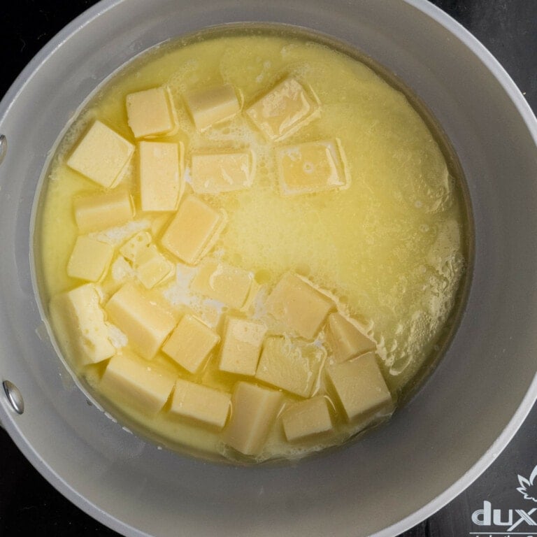 Cheese, butter, and milk melted in a pot over low heat