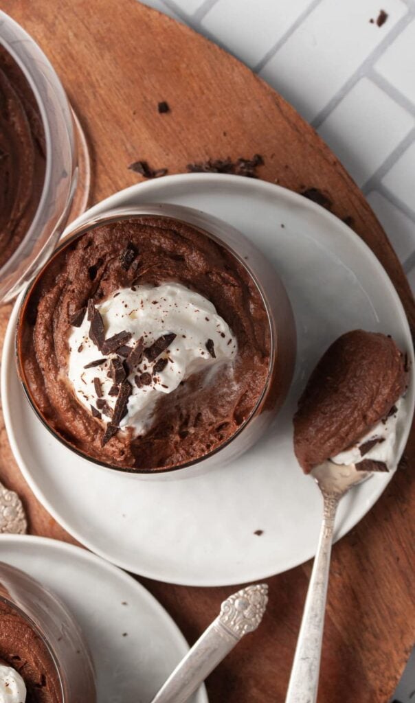 A glass of boozy chocolate mousse with a spoonful scooped out.