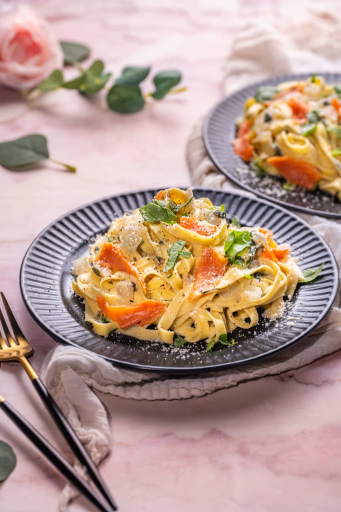 Two plates of Creamy Smoked Salmon Pasta with fork and spoon