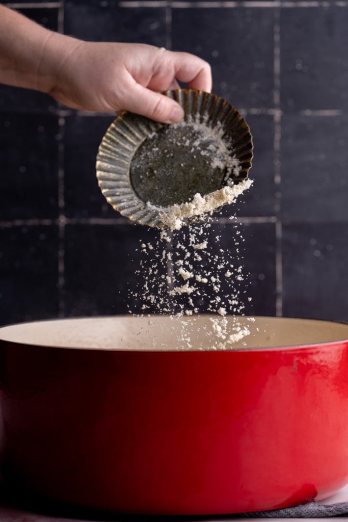 Adding Parmesan to Creamy Smoked Salmon Pasta