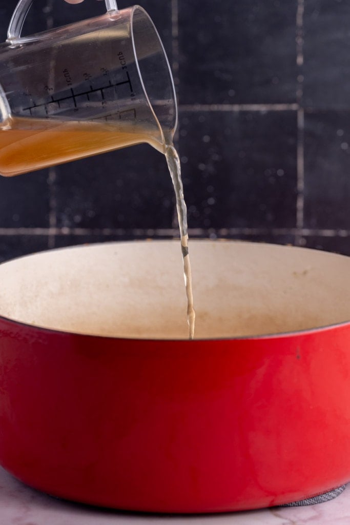 Pouring vegetable broth over fresh pasta