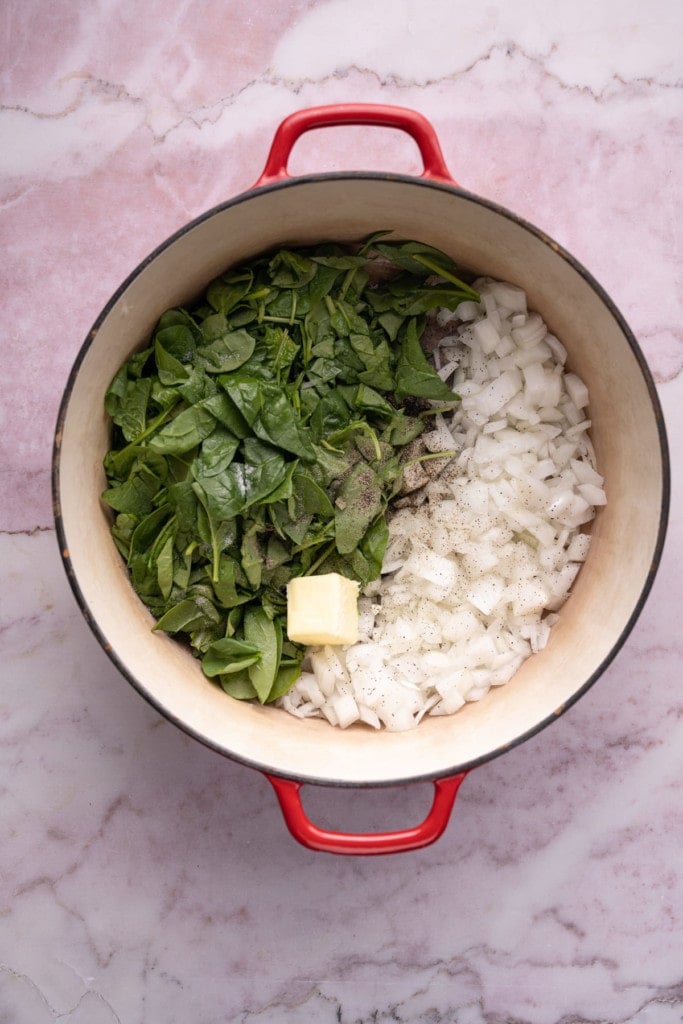 Sautéing spinach and onion in butter, salt, and pepper