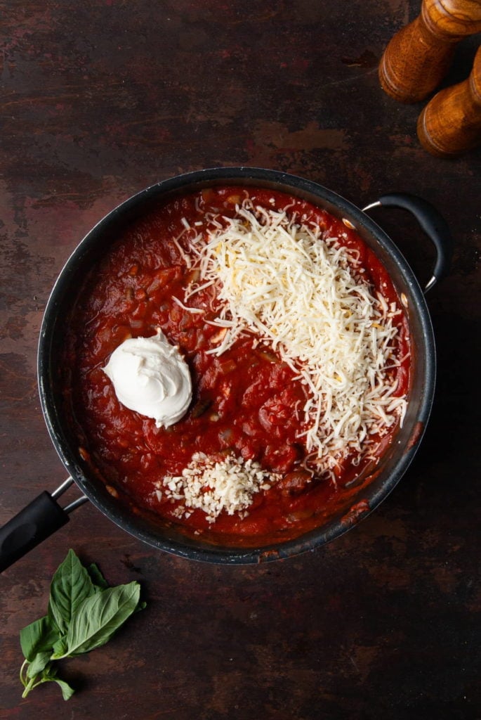 cream cheese, minced garlic, and shredded cheese in marinara sauce