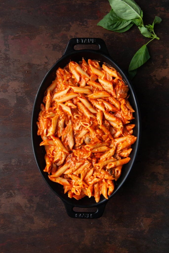 Pasta covered in sauce in a baking dish.