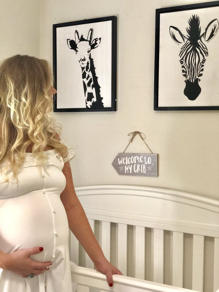 Pregnant Mom Looking Over Crib | FurloughedFoodie.com