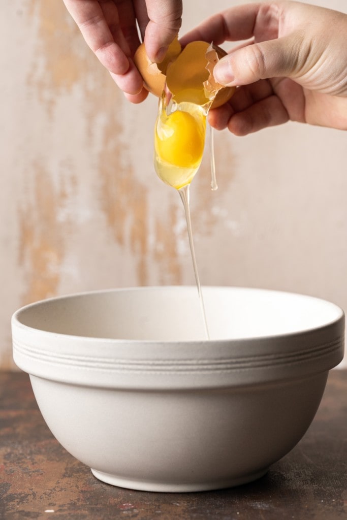 Cracking egg into mixing bowl