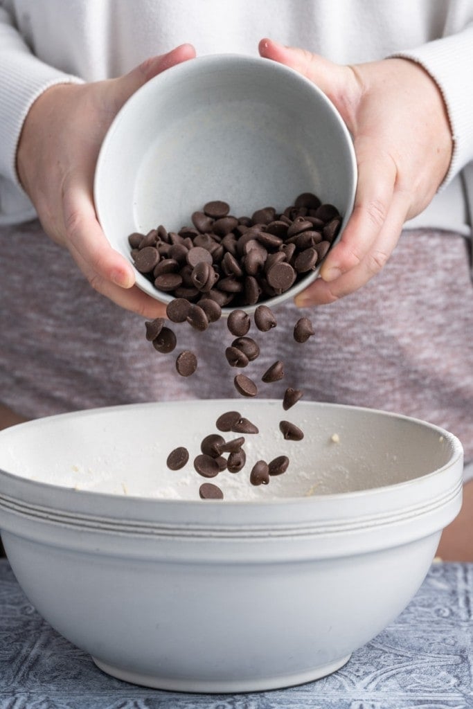 Adding chocolate chips to large mixing bowl