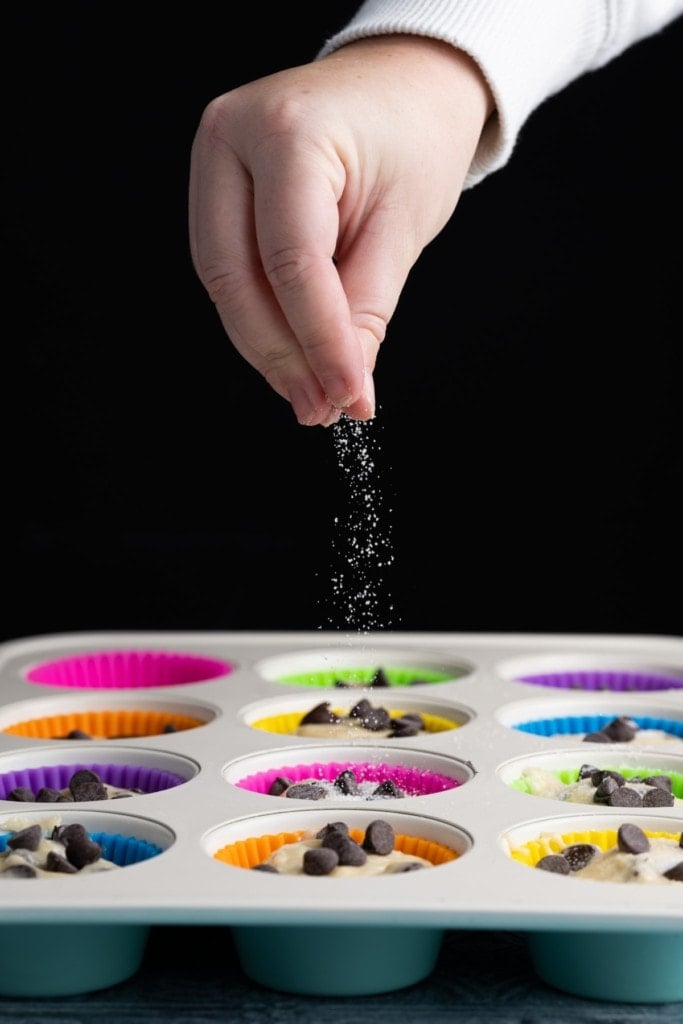 Sprinkling sugar on top of one-bowl chocolate chip muffins just before the oven