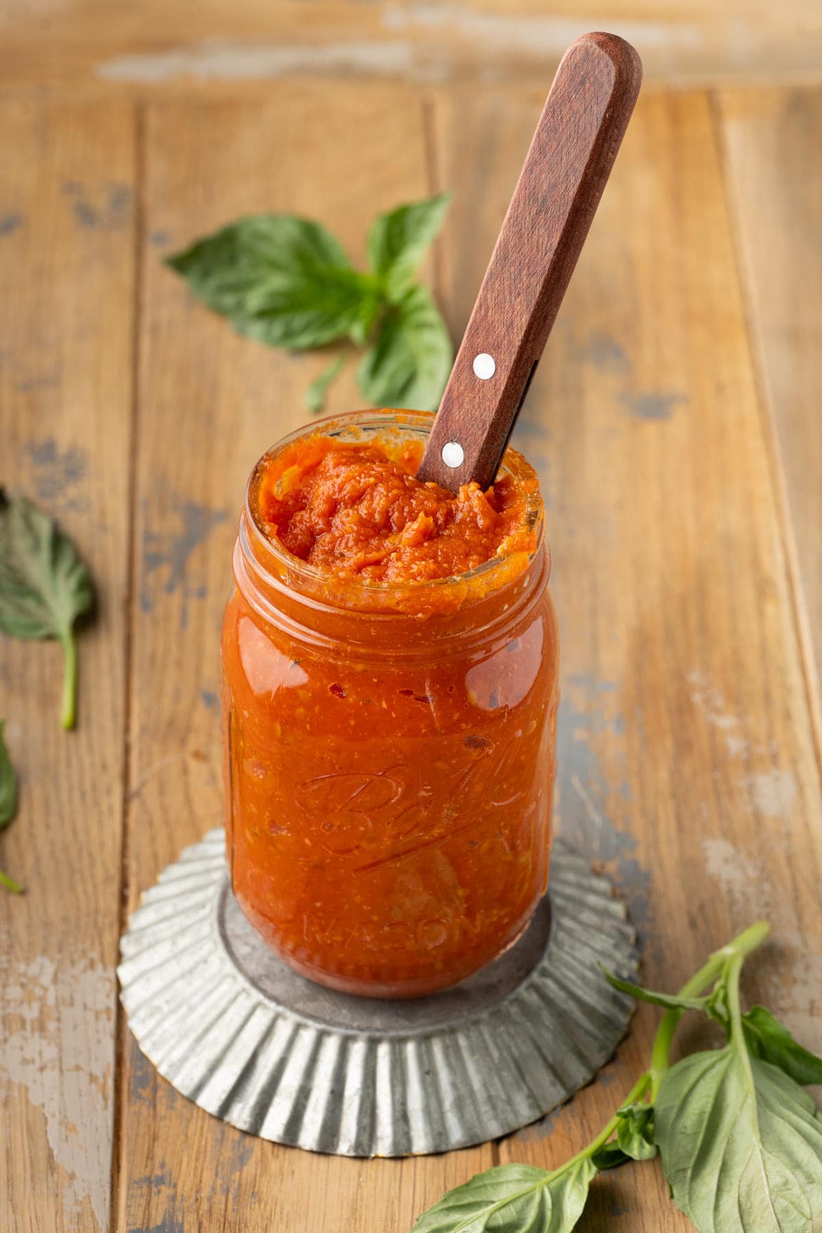 Mason jar filled with homemade pizza sauce made from roasted tomatoes. 