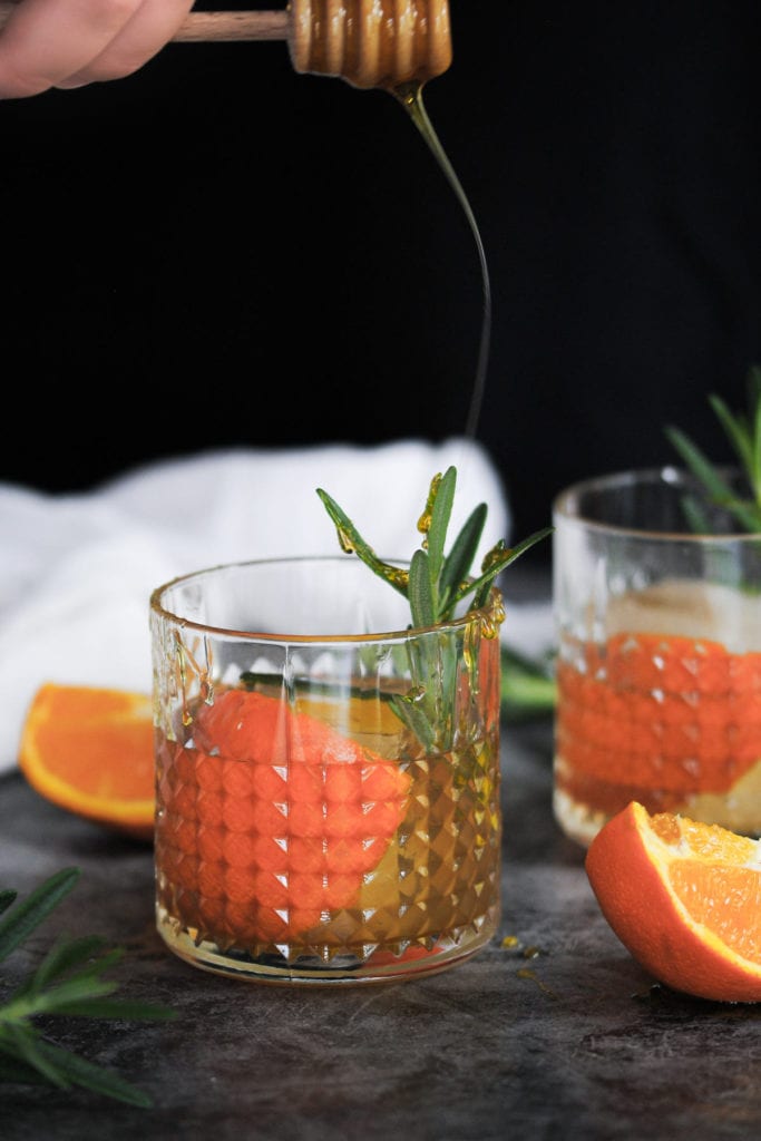 Honey Flying off honey dipper and landing on rosemary garnish