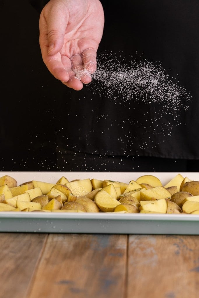 seasoning potatoes with salt