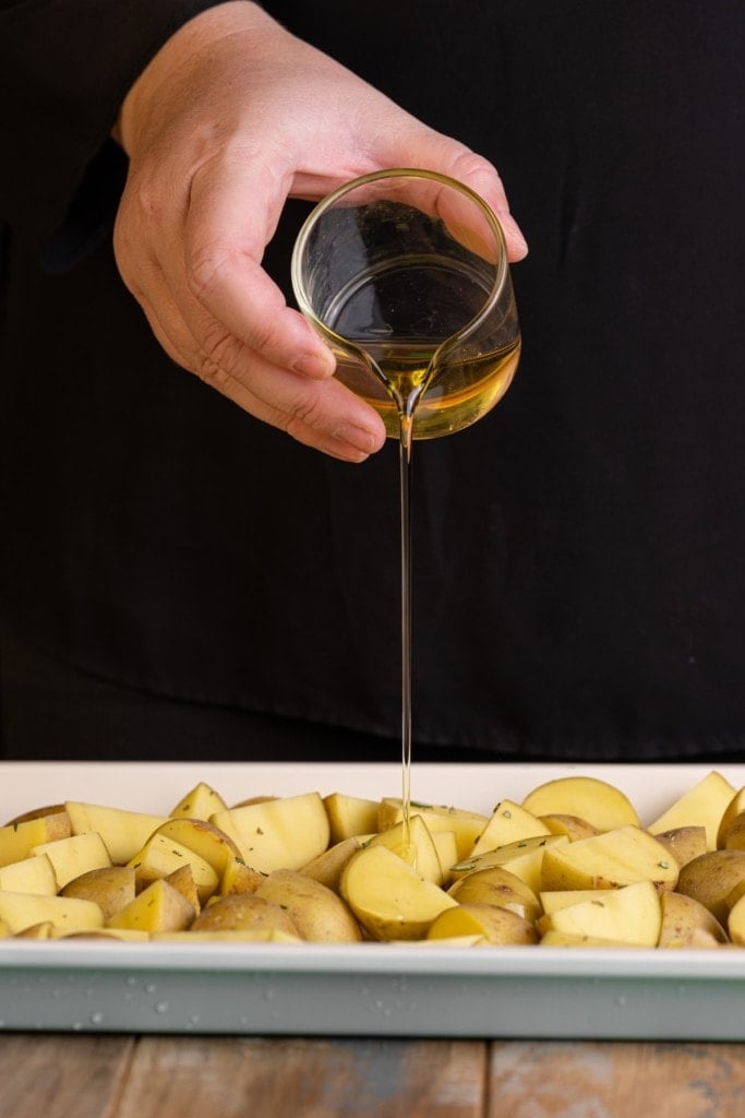 coating Honey Gold potatoes in olive oil to roast