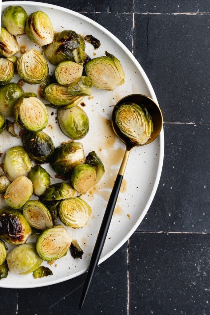 close up of sweet and salty brussels sprouts with one sprout on a spoon