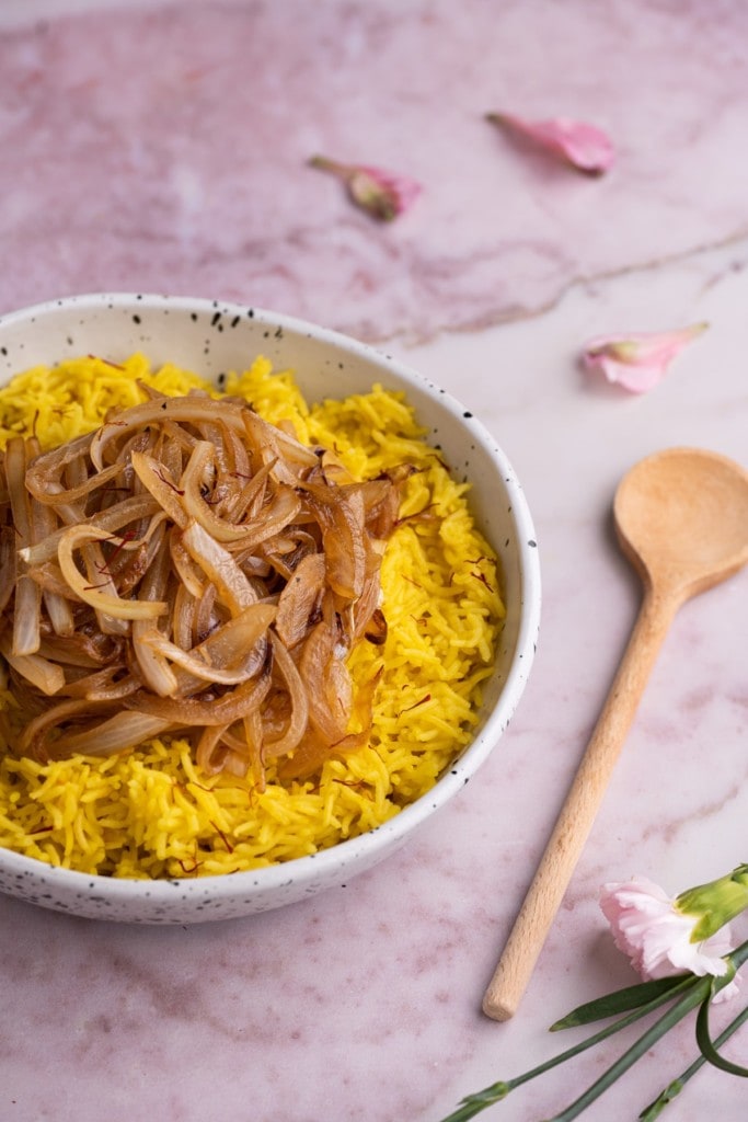 Bowl of Yellow Saffron Rice topped with caramelized onions