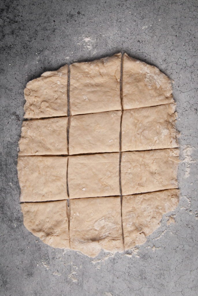 Cutting dough into 12 roughly equal-sized pieces.