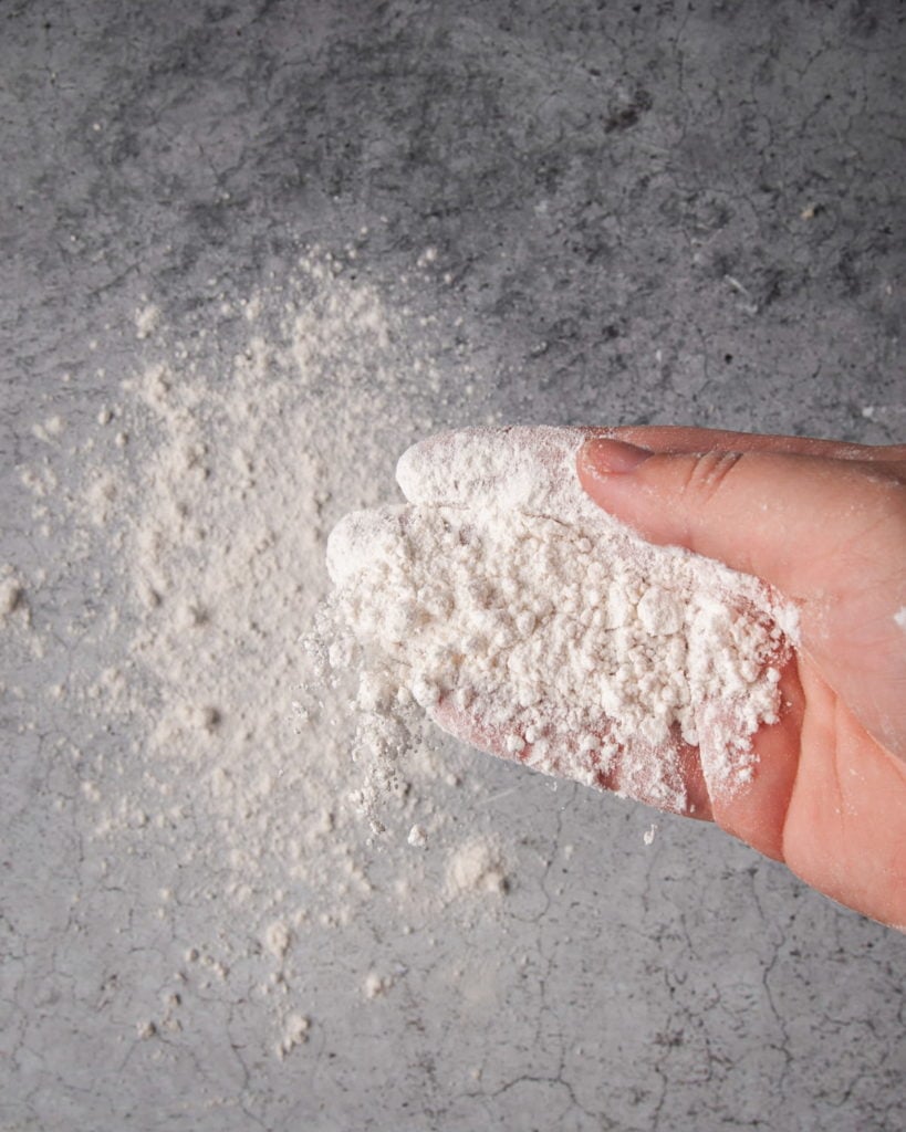 using a hand to flour a surface