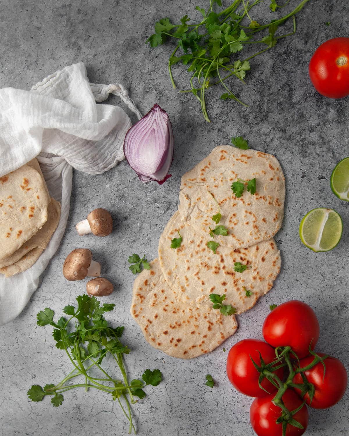homemade tortillas surrounded by fresh ingredients