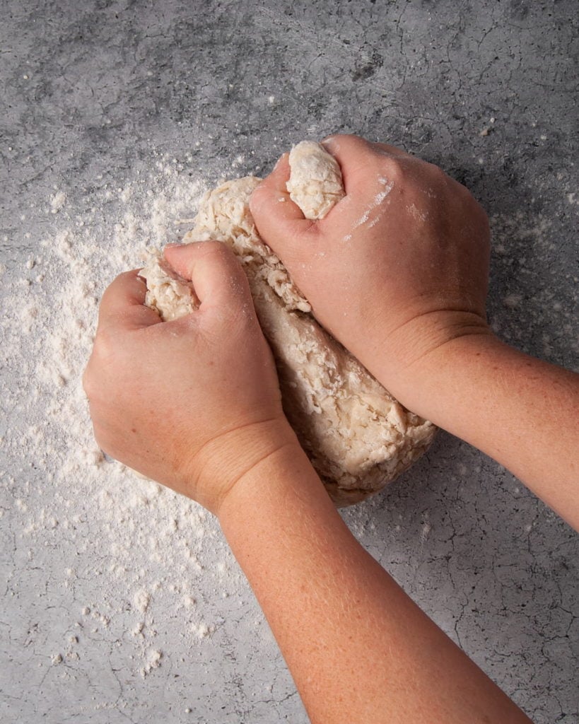 kneading dough on a floured surface