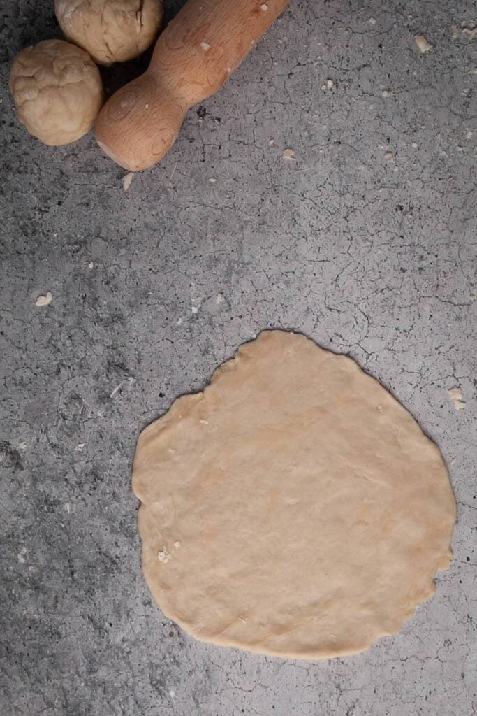 Flattening dough into tortillas.