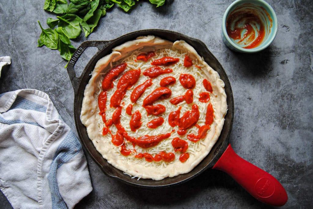 Quick Knead and Rise Pizza Dough - Adding Sauce