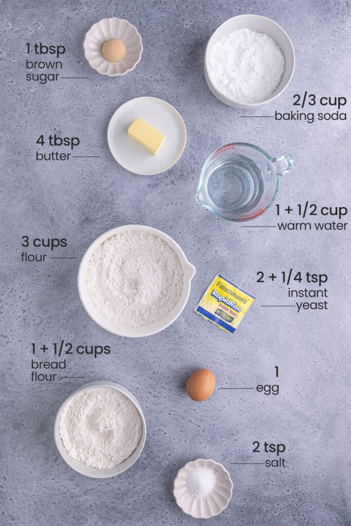 Ingredients for Soft German Pretzels including brown sugar, baking soda, butter, water, all-purpose flour, instant yeast, egg, bread flour, and salt