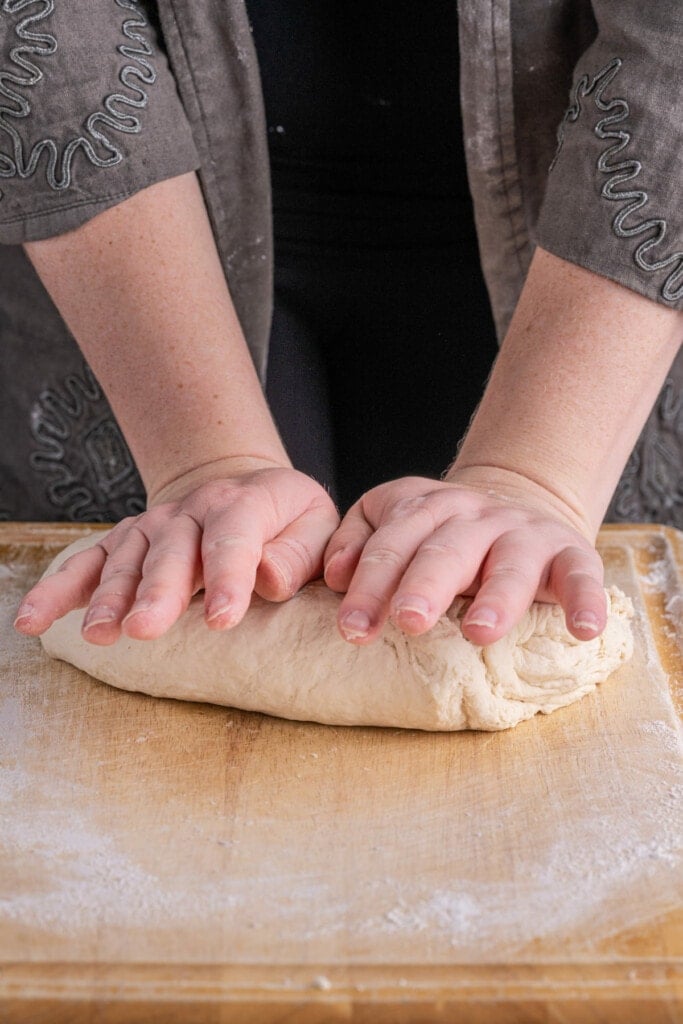 Kneading pretzel dough together 