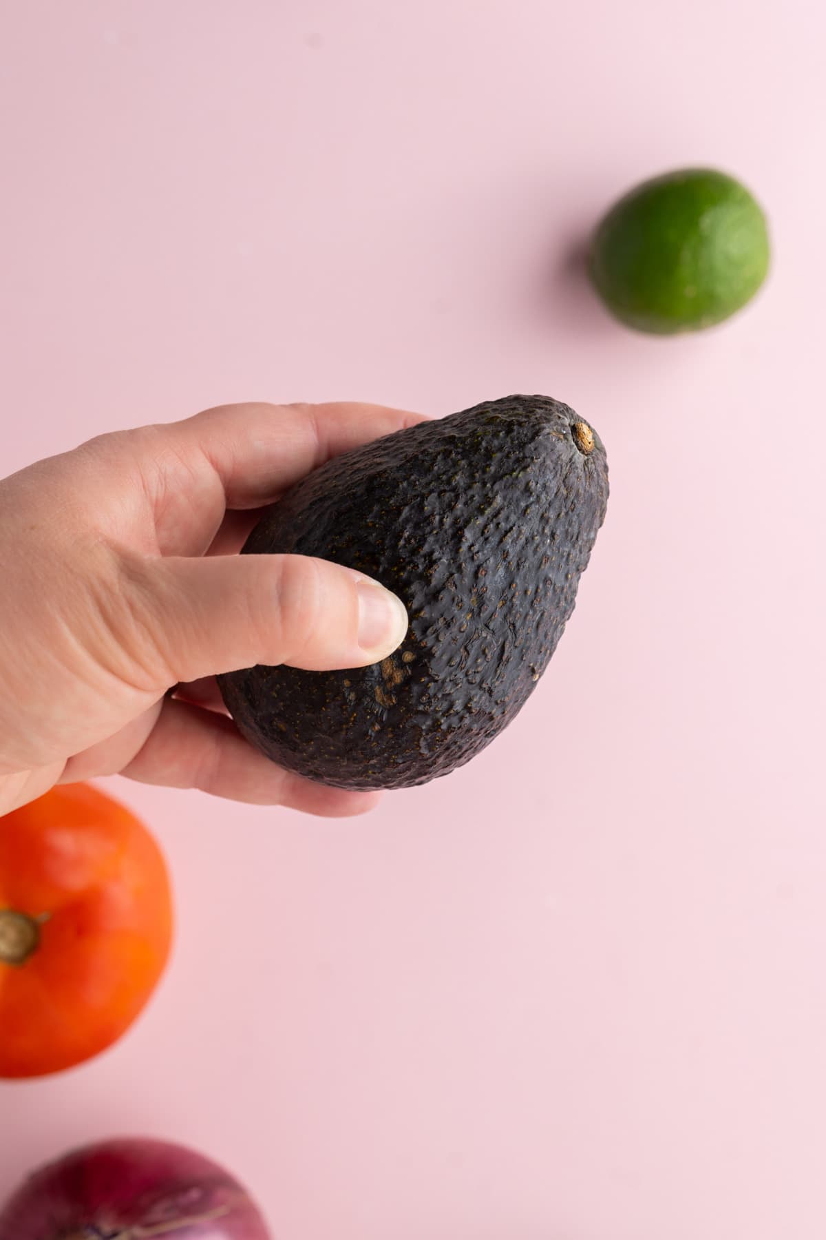 Squeezing avocado to test ripeness