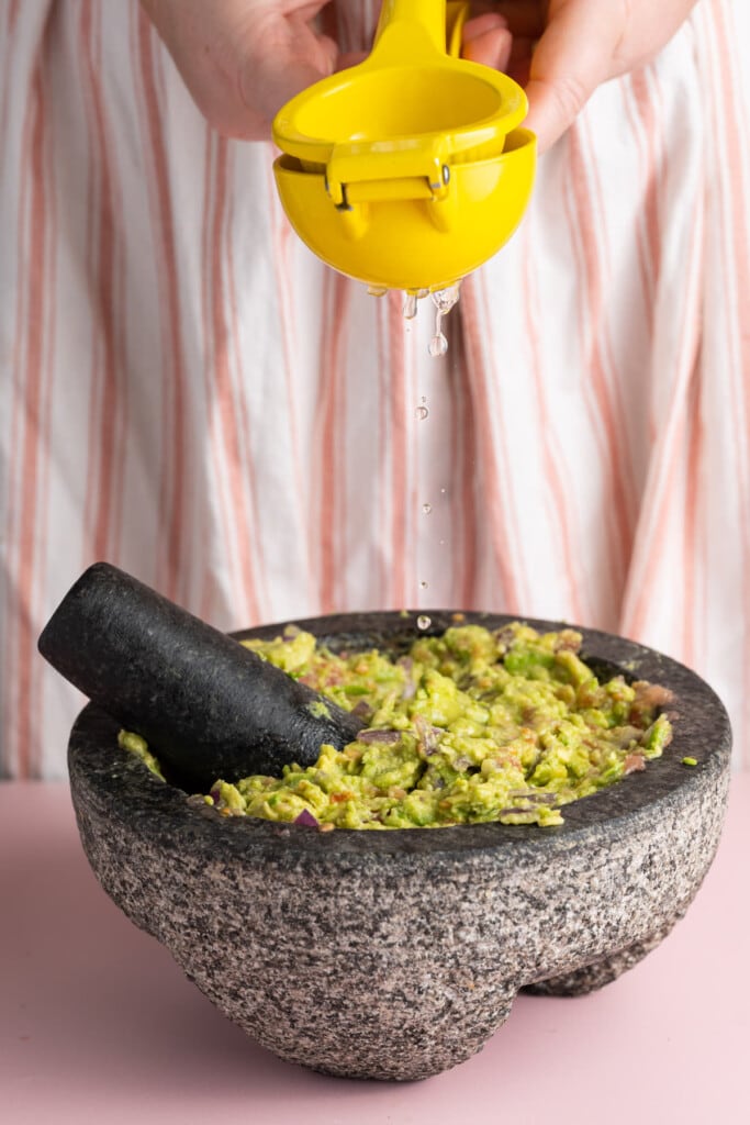 Squeezing fresh lime juice into guacamole
