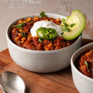 close up of a bowl of vegan chili with fresh toppings