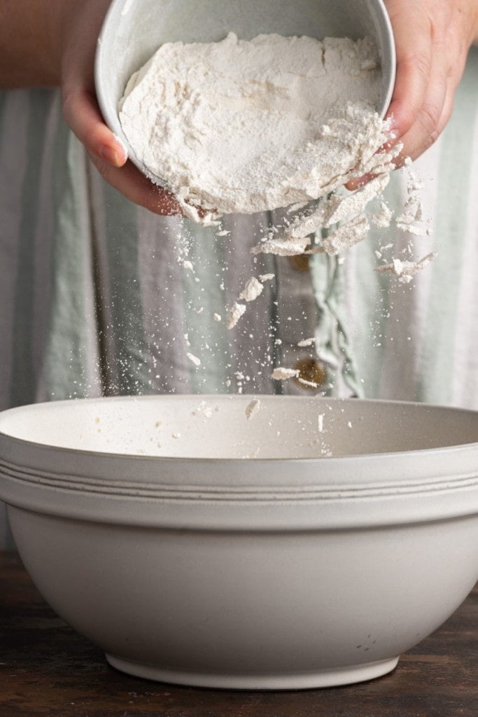 adding all-purpose flour to cookie dough cup batter