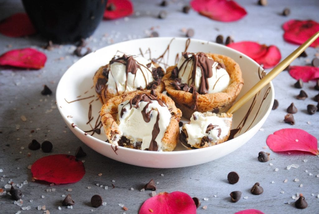 picture of cookie dough ice cream cups with bite on spoon