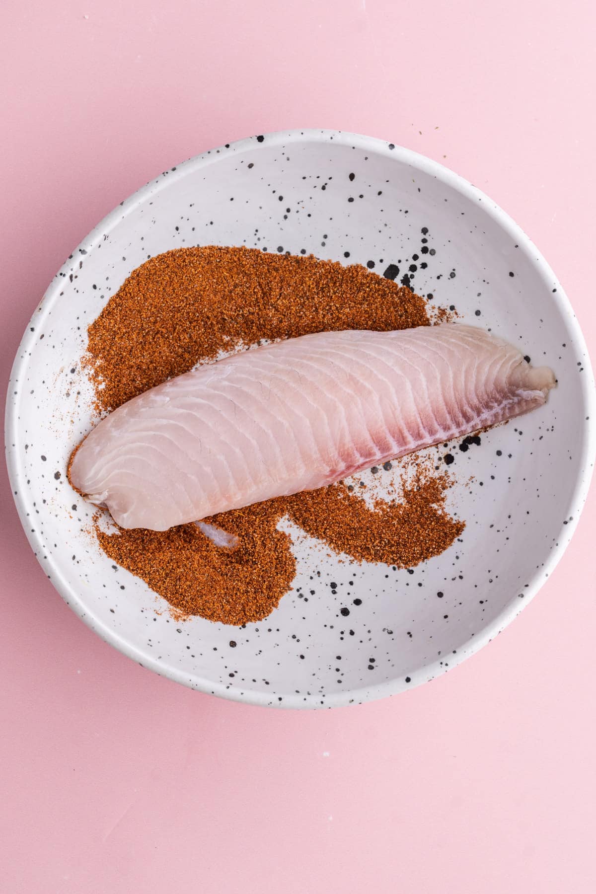 Coating fish in taco seasoning for fish tacos