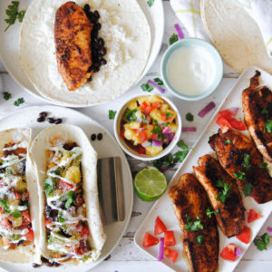 two fish tacos and a plate of fish