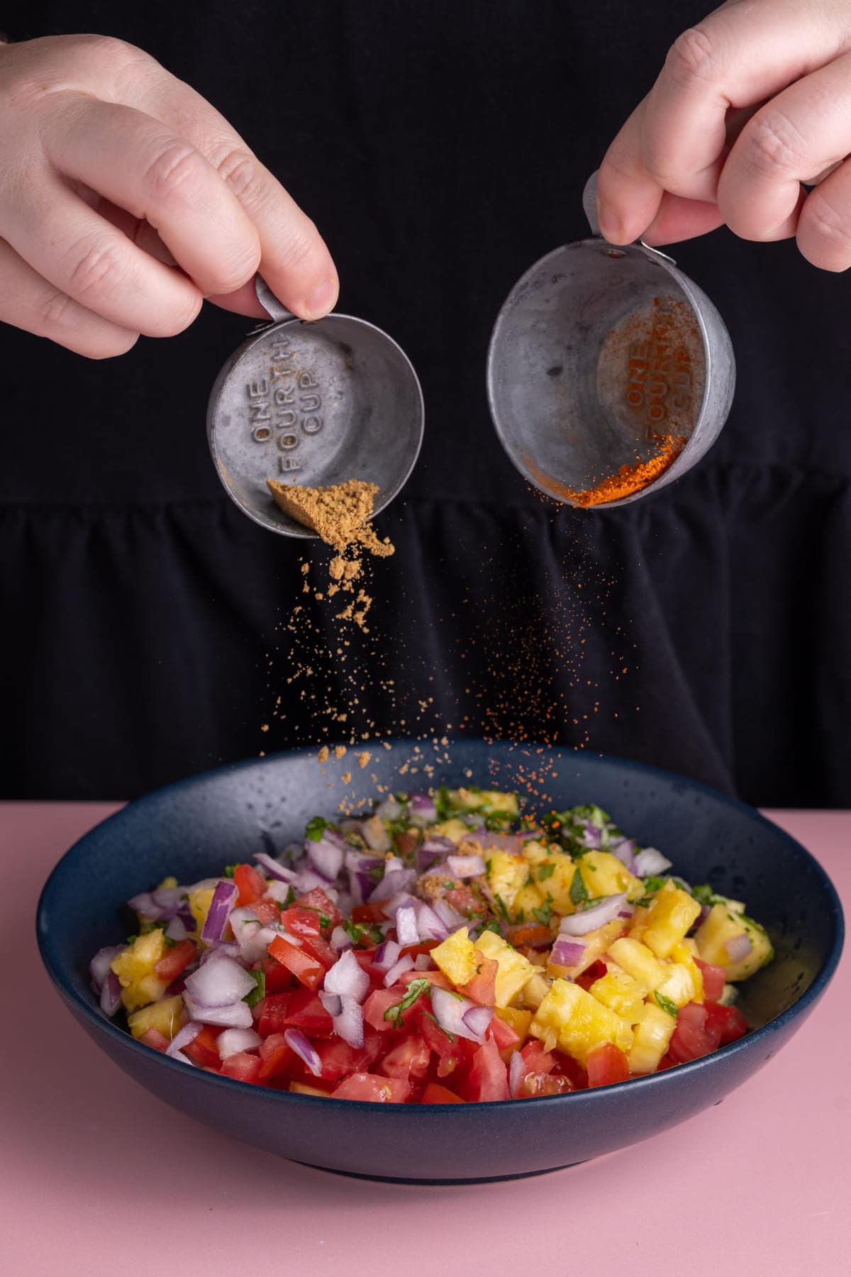 Adding cumin and cayenne pepper to Pineapple Pico de Gallo