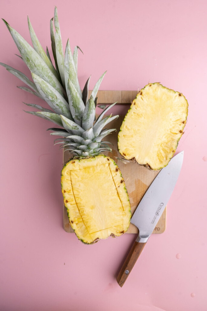 Cutting half of pineapple to core out and make a serving bowl