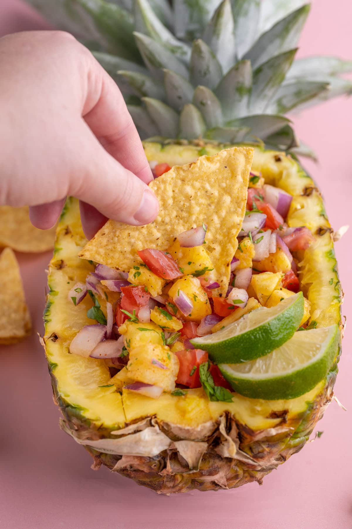 Dipping a tortilla chip into Pineapple Pico de Gallo