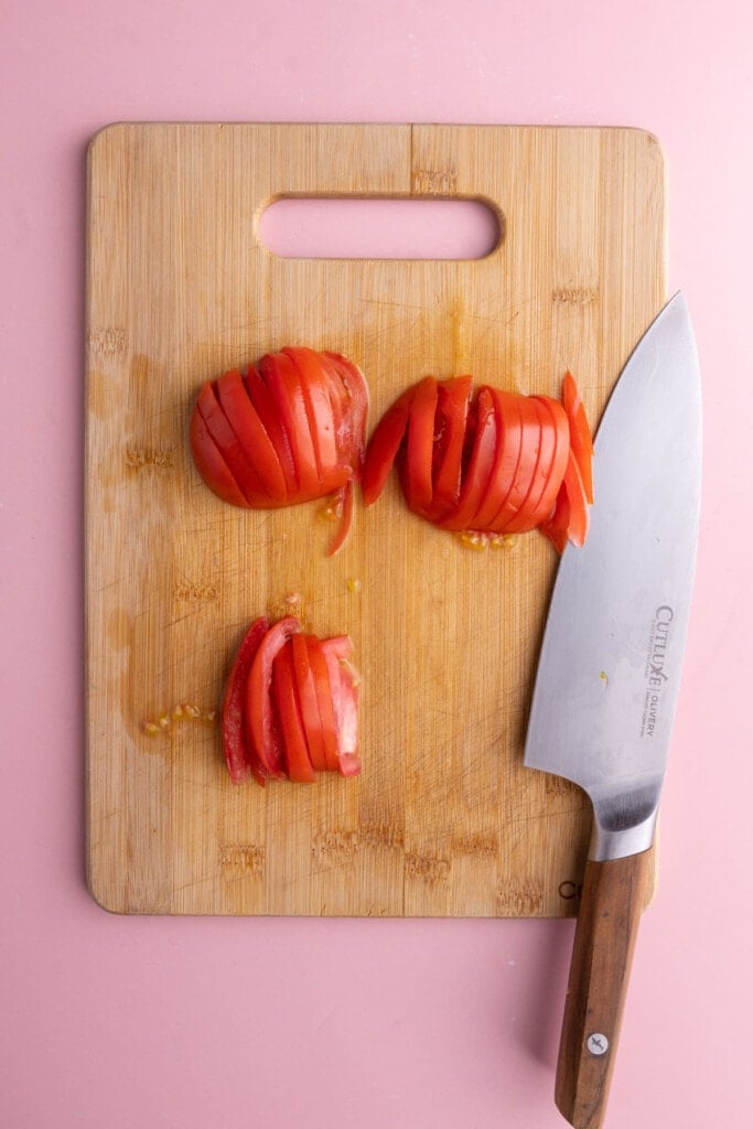 Slicing tomato on a cutting board