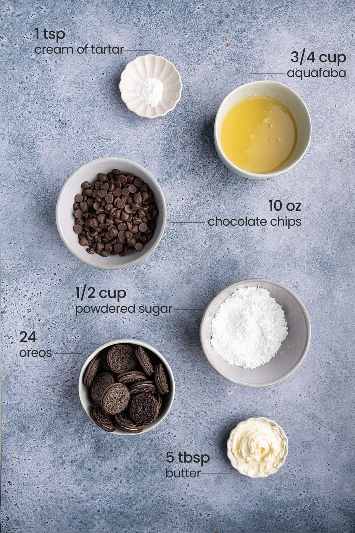 All ingredients for Vegan Chocolate Pie with Aquafaba including cream of tartar, aquafaba, vegan chocolate chips, powdered sugar, Oreos, and vegan butter