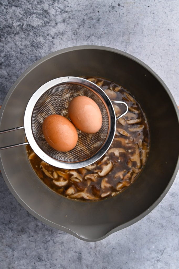 soft boiling eggs in vegetarian ramen broth