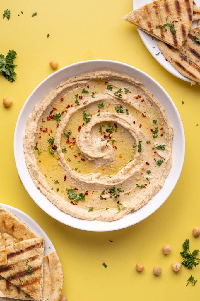 Overhead image of 5-Minute Hummus garnished with parsley and crushed red pepper