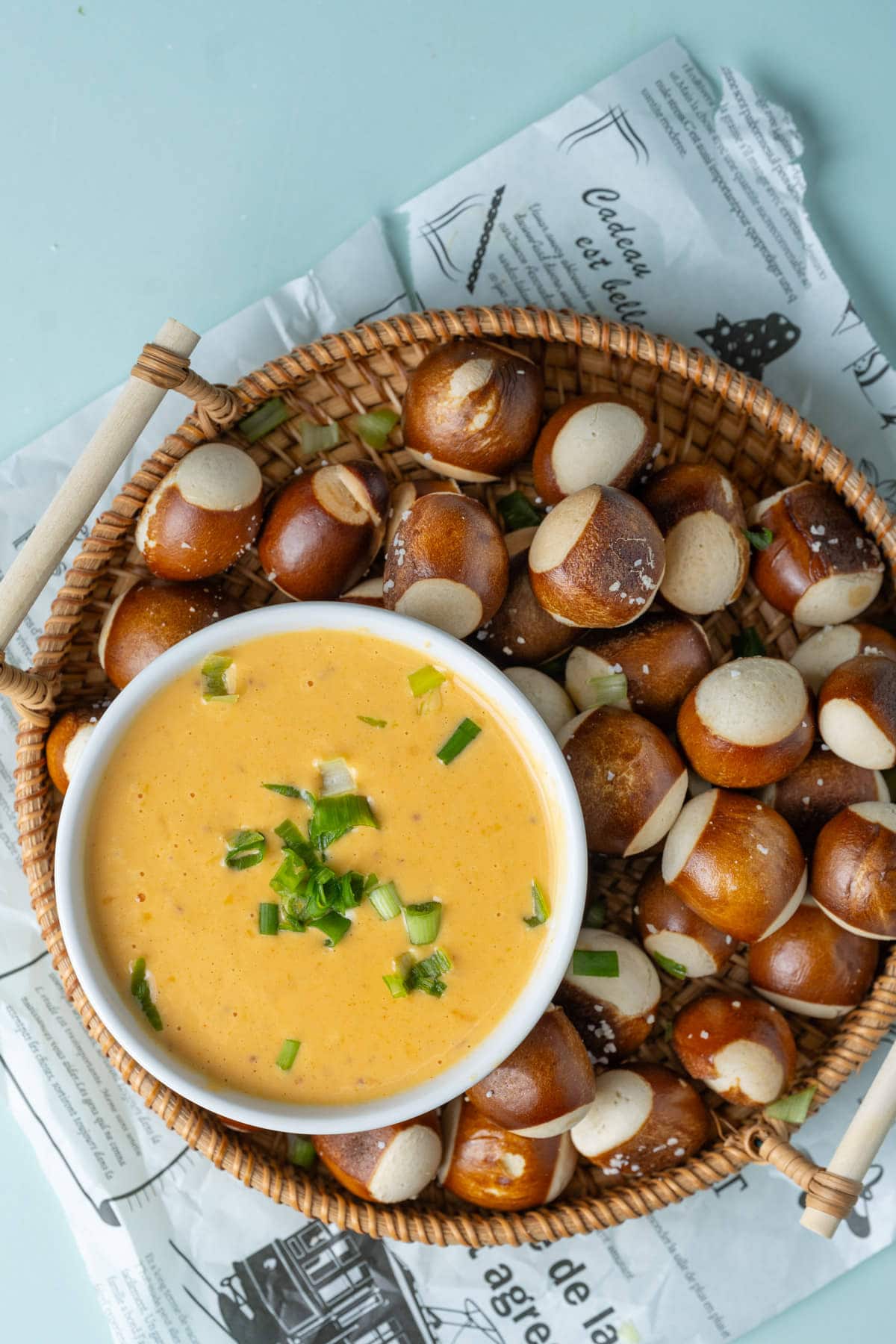 Basket of pretzel bites served with a bowl of beer cheese.