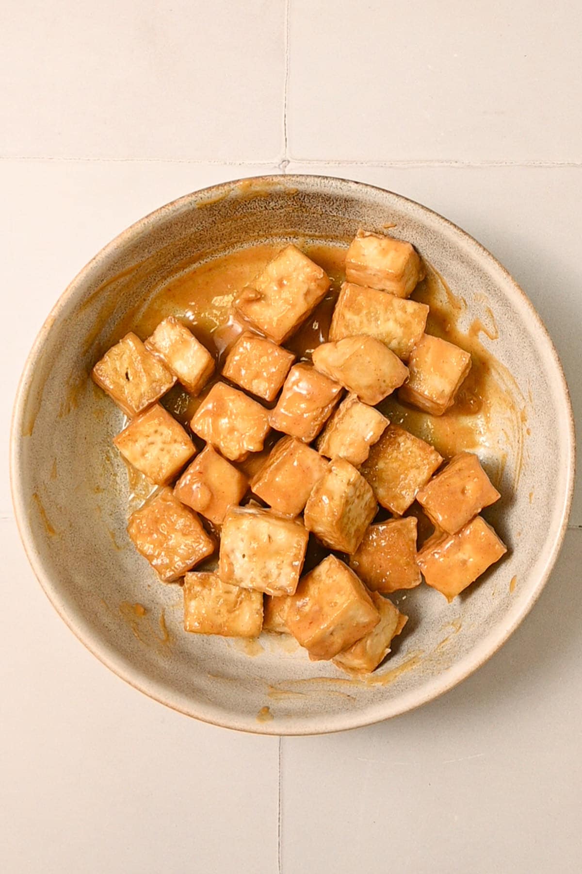 Crispy cubed tofu tossed in creamy spicy peanut sauce. 