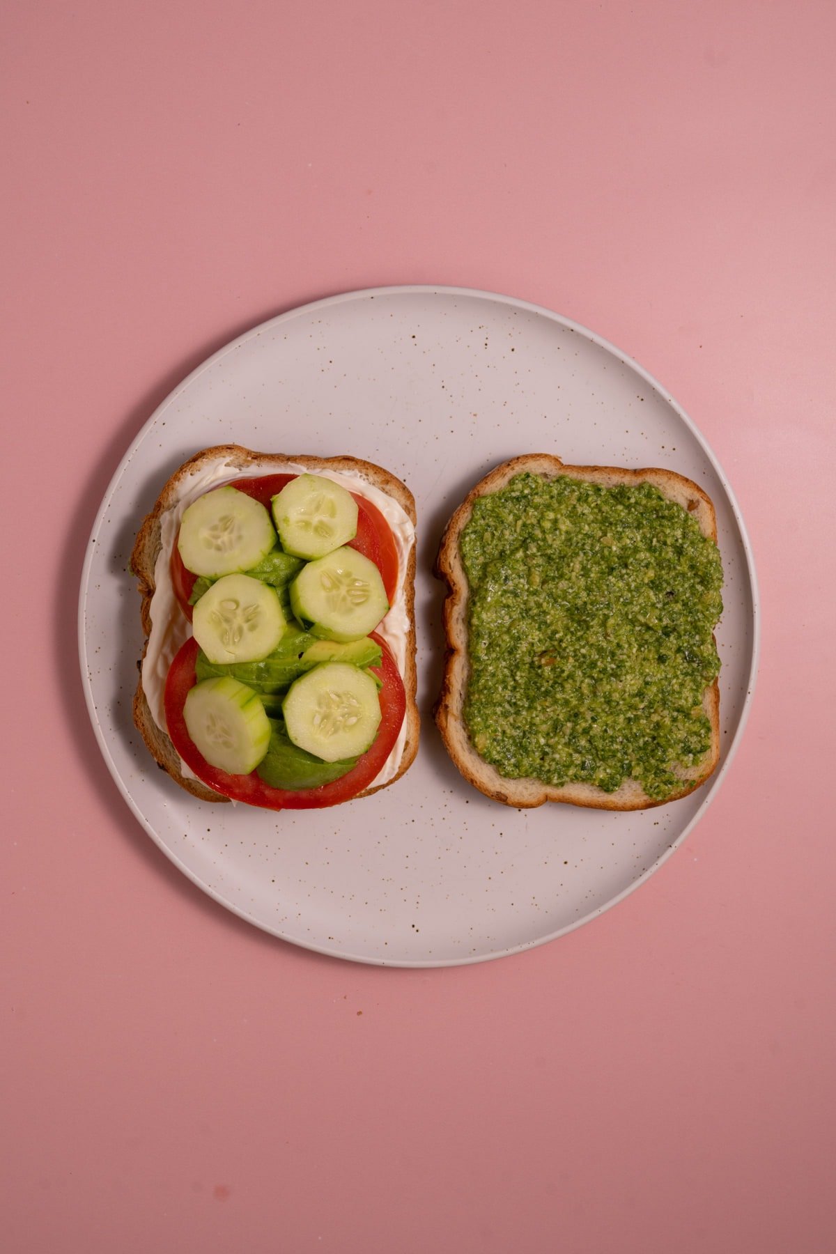 Stack the cucumber on the loaded veggie sandwich next