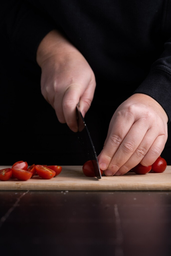 Slicing grape tomatoes in half