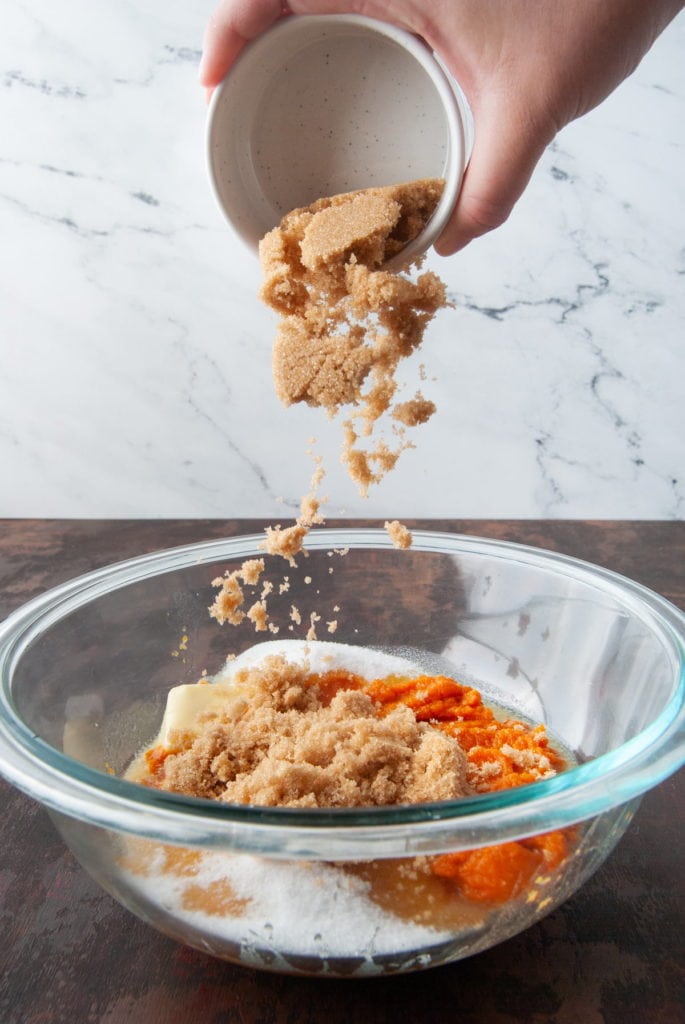 Creaming sugar and pumpkin puree and butter.