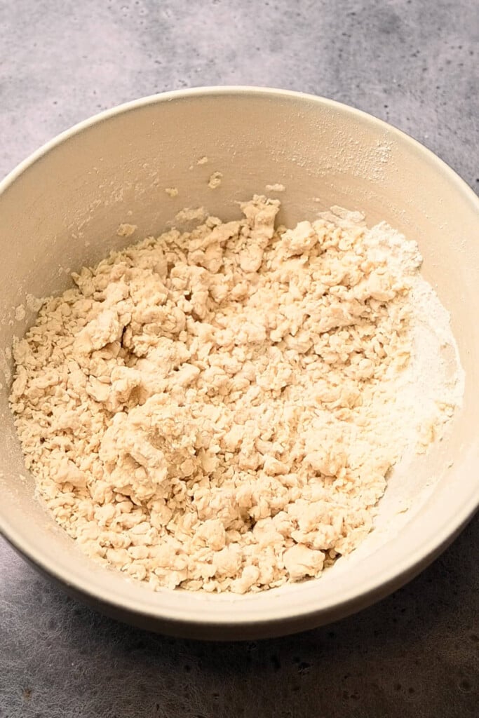 Mixing flour, sugar, baking powder, salt, and milk together to make a simple biscuit dough.