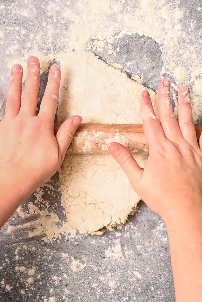 Rolling butter into dough for the flakiest biscuits.