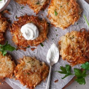 Platter of Great Grandmas Traditional Potato Latkes with sour cream