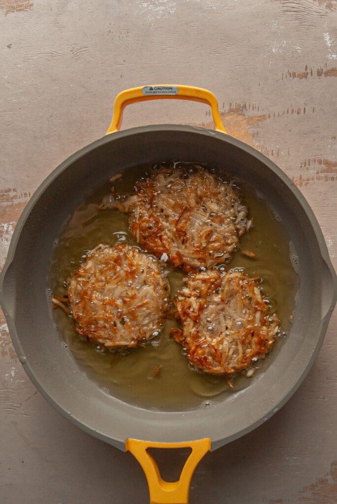 latkes frying in a pan